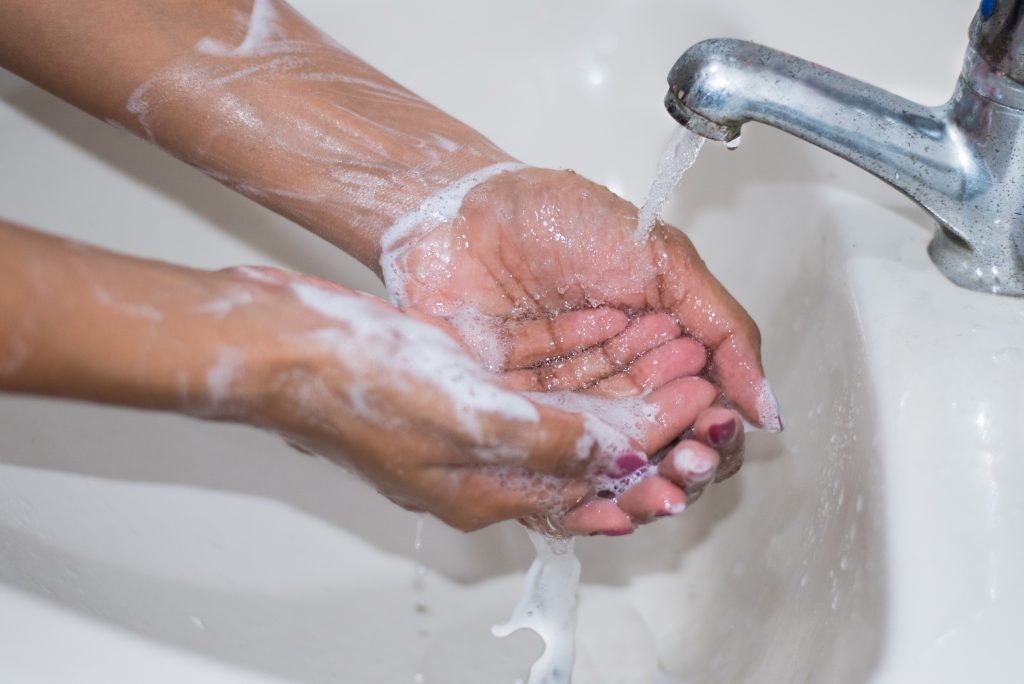 Image of person washing hands, to prevent the spread of covid-19